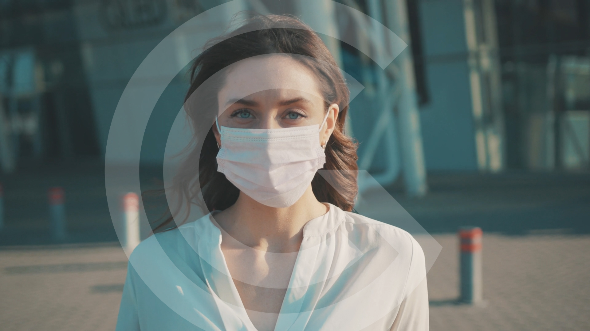 Woman wearing a mask and looking to camera